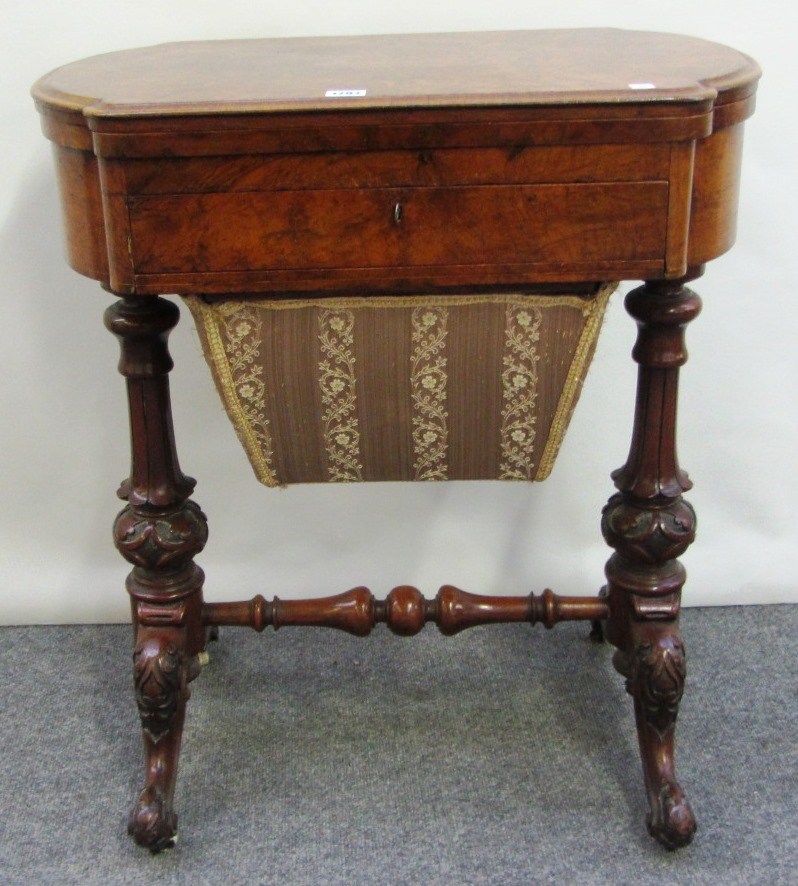 Appraisal: A Victorian walnut sewing games table the rounded rectangular top