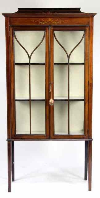 Appraisal: An Edwardian mahogany display cabinet with glazed door and inlaid