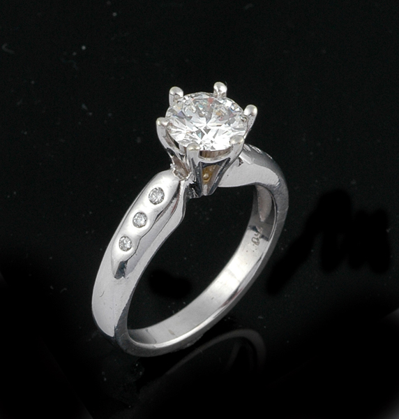 Appraisal: A diamond solitaire ring The round brilliant cut diamond weighing