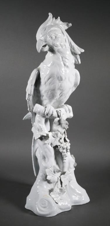 Appraisal: White glazed porcelain parrot rest upon a tree stump with