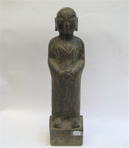 Appraisal: AN ASIAN GRANITE SCULPTURE depicting the standing Buddha raised on