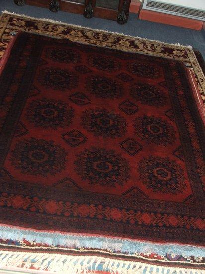 Appraisal: A TURKISH WINE GROUND RUG - decorated a central large