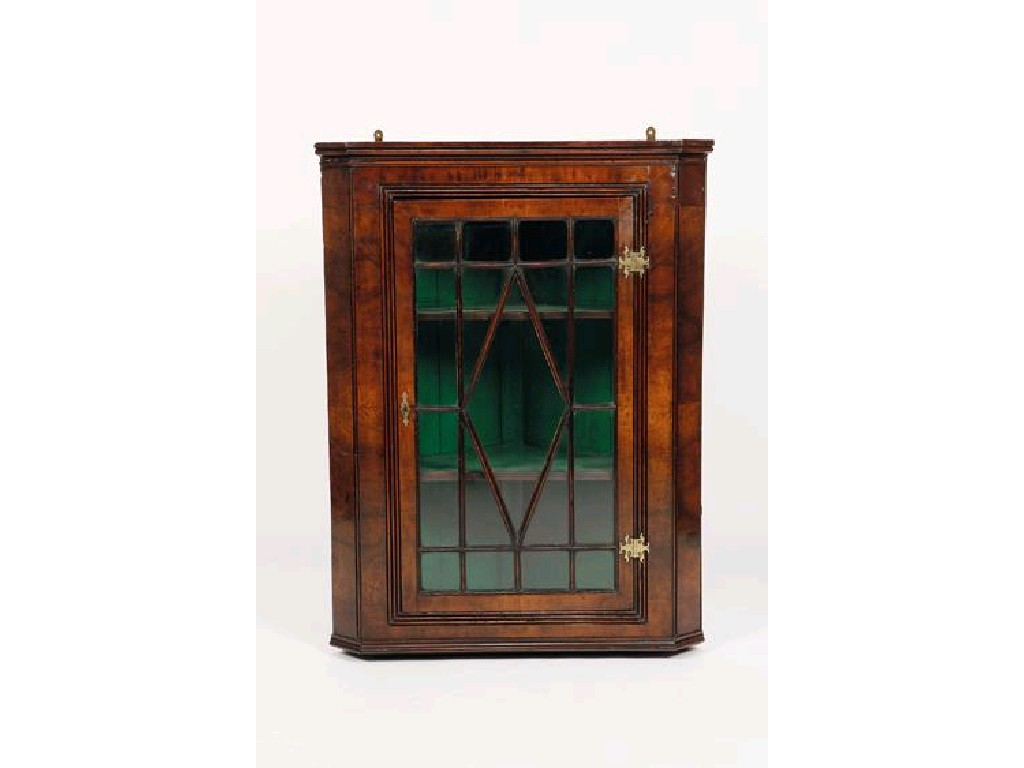 Appraisal: A GEORGE III WALNUT VENEERED HANGING CORNER CUPBOARD with a