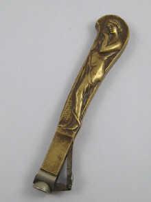 Appraisal: A cast brass table cigar cutter decorated with an Art