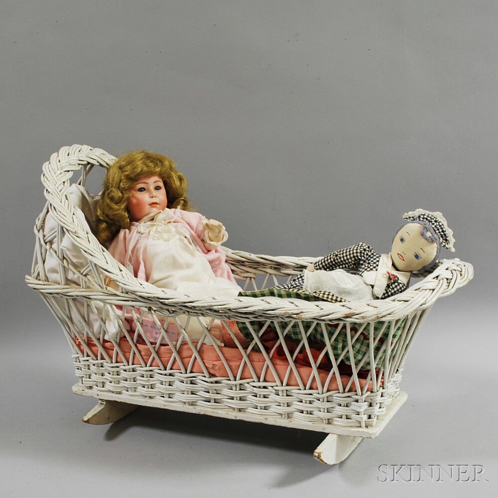 Appraisal: Two Dolls and a White Wicker Cradle a topsy-turvy cloth