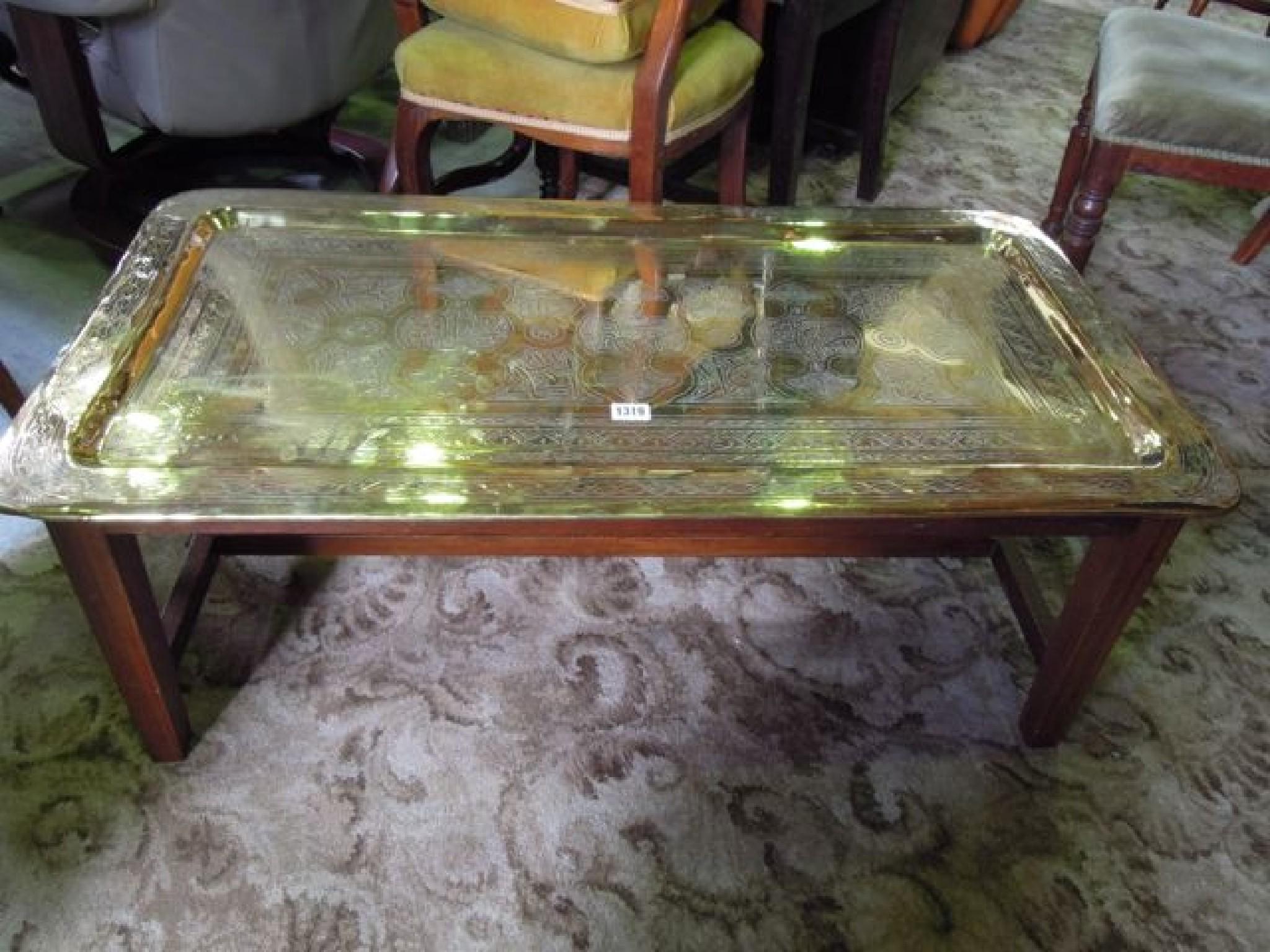 Appraisal: An Eastern polished brass tray top occasional table with engraved