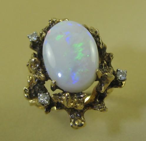 Appraisal: OPAL DIAMOND AND FOURTEEN KARAT GOLD RING featuring a single