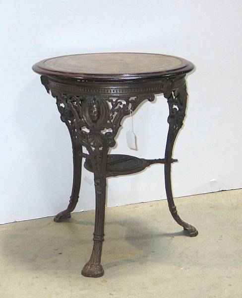 Appraisal: An inlaid walnut and painted cast iron pub table th