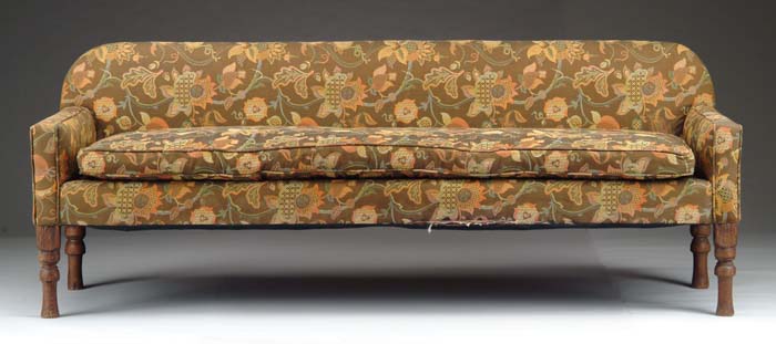 Appraisal: UPHOLSTERED ANTIQUE COUNTRY SOFA Turned legs over upholstered arms and