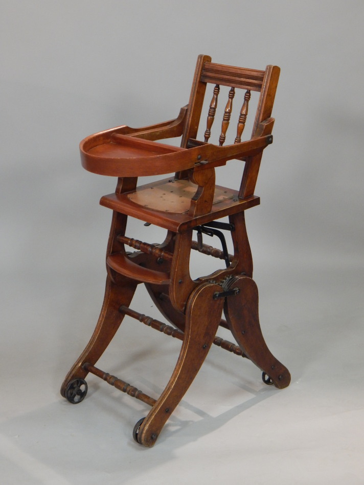 Appraisal: A Victorian walnut child's high chair with a later hardboard