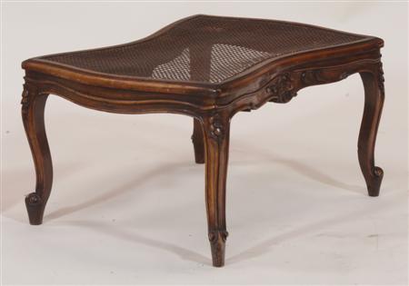 Appraisal: A mahogany serpentine caned centre stool the moulded top raised