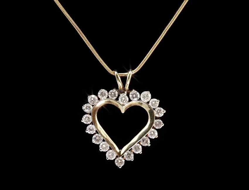 Appraisal: DIAMOND HEART PENDANT NECKLACE K yellow gold pendant contains round