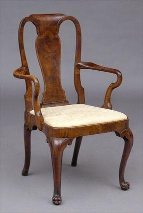 Appraisal: QUEEN ANNE WALNUT VENEERED ARMCHAIR The arched cresting above a