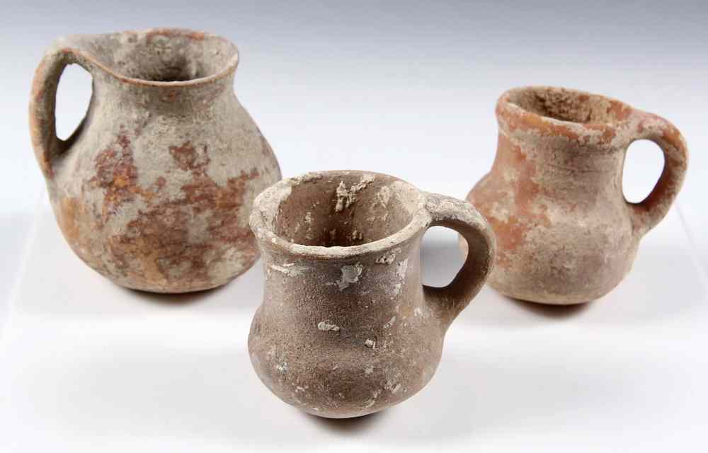 Appraisal: ANCIENT VESSELS - Three Small Clay Drinking Jugs found in