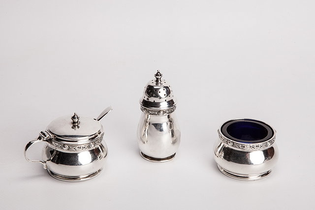 Appraisal: AN ARTS AND CRAFTS SILVER THREE PIECE CONDIMENT SET comprising