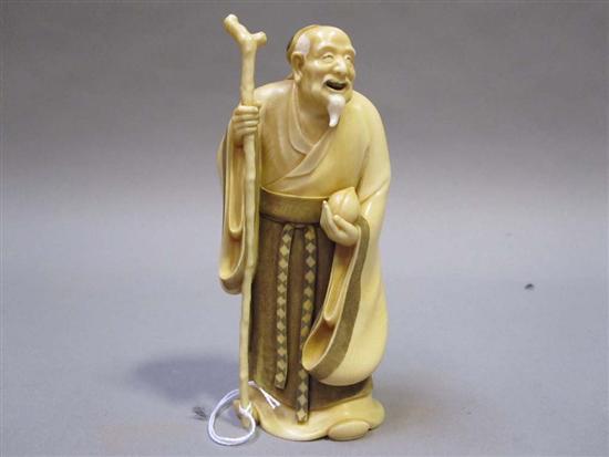 Appraisal: JAPANESE IVORY OKIMONO OF A BEARDED ELDER th C Holding