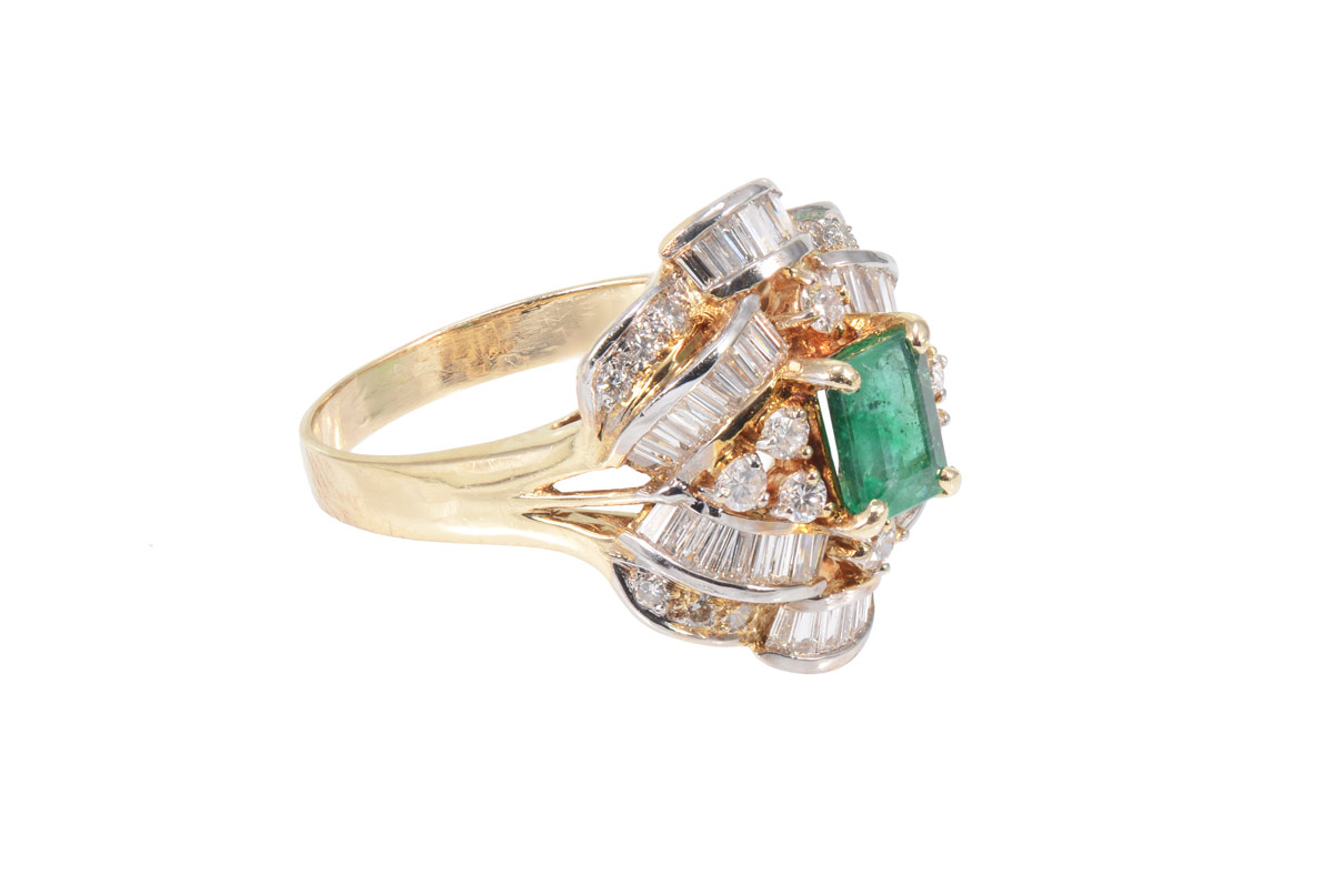 Appraisal: EMERALD AND DIAMOND RING k yellow gold ring centering an