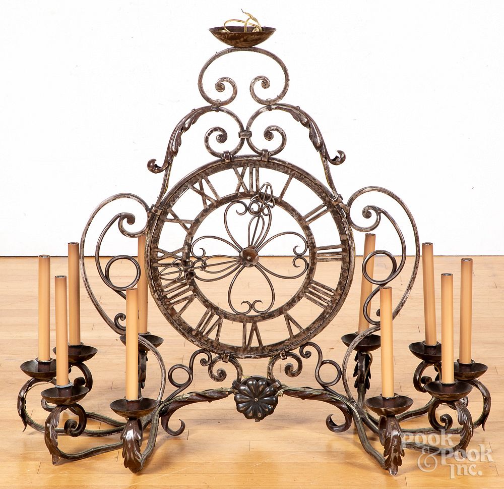 Appraisal: Iron ten-arm chandelier Iron ten-arm chandelier with clock face center