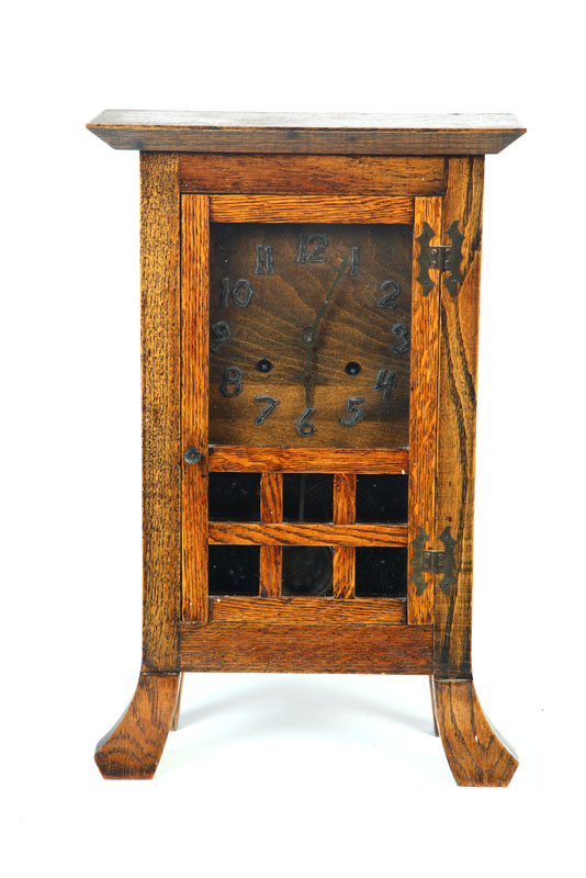 Appraisal: ARTS CRAFTS MANTEL CLOCK American early th century oak Shaped