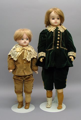 Appraisal: Pair of boy dolls with glass eyes and dressed in