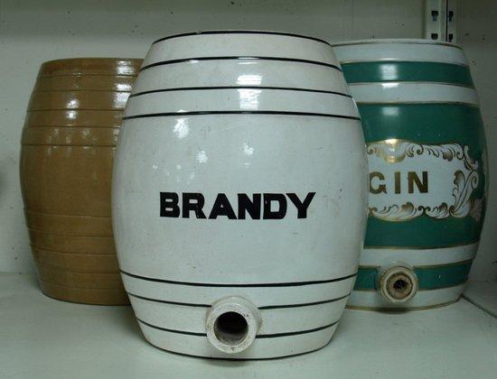 Appraisal: A white glazed brandy cask with black banding a brown