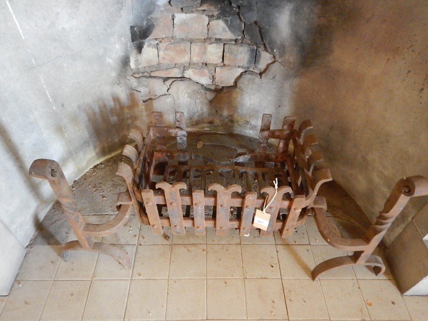 Appraisal: A cast iron fire grate with castleated basket