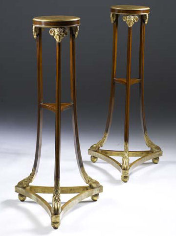 Appraisal: A pair of Victorian parcel gilt mahogany tripod torchere stands