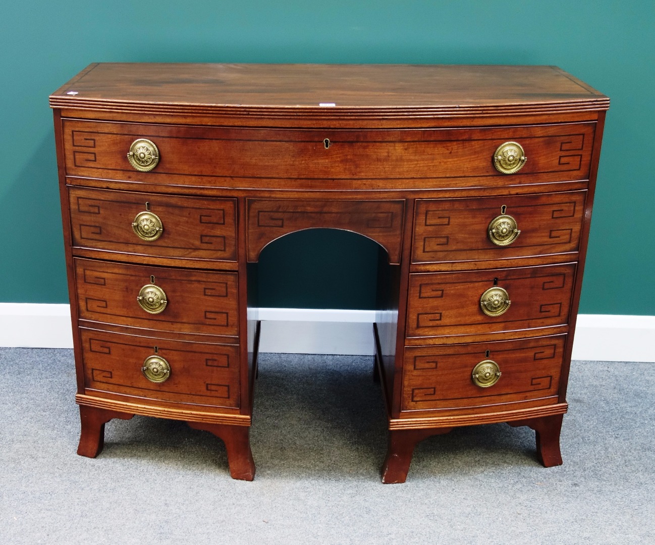 Appraisal: An early th century inlaid mahogany bowfront sideboard with one