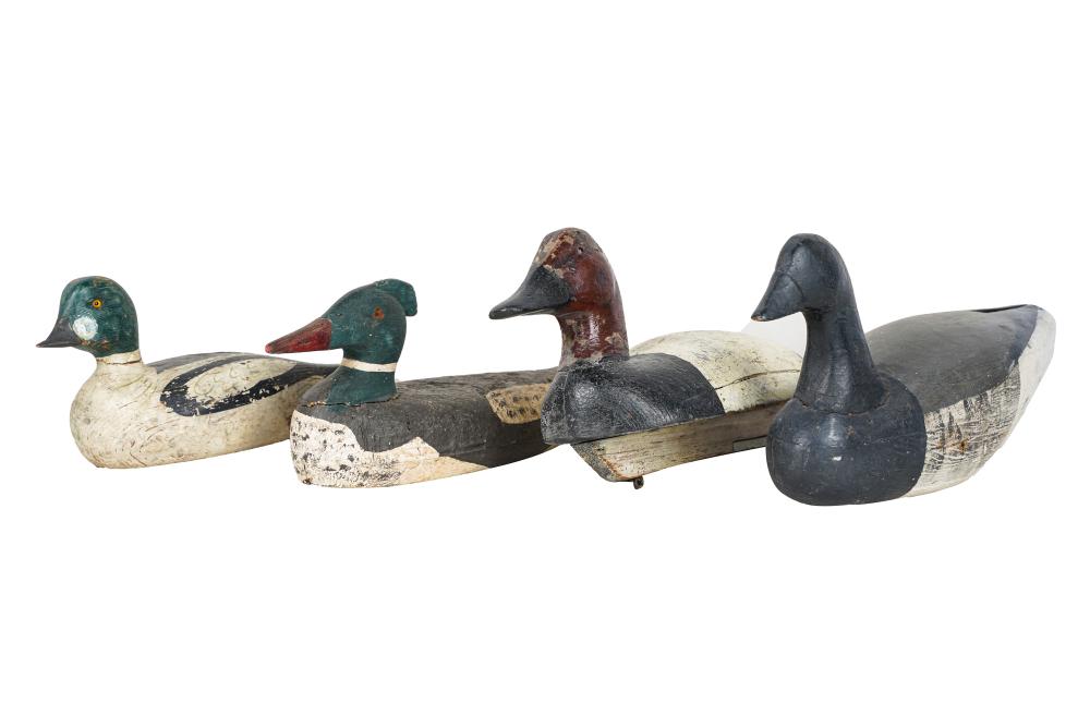 Appraisal: FOUR PAINTED CARVED WOOD DUCK DECOYSCondition with loss and repair