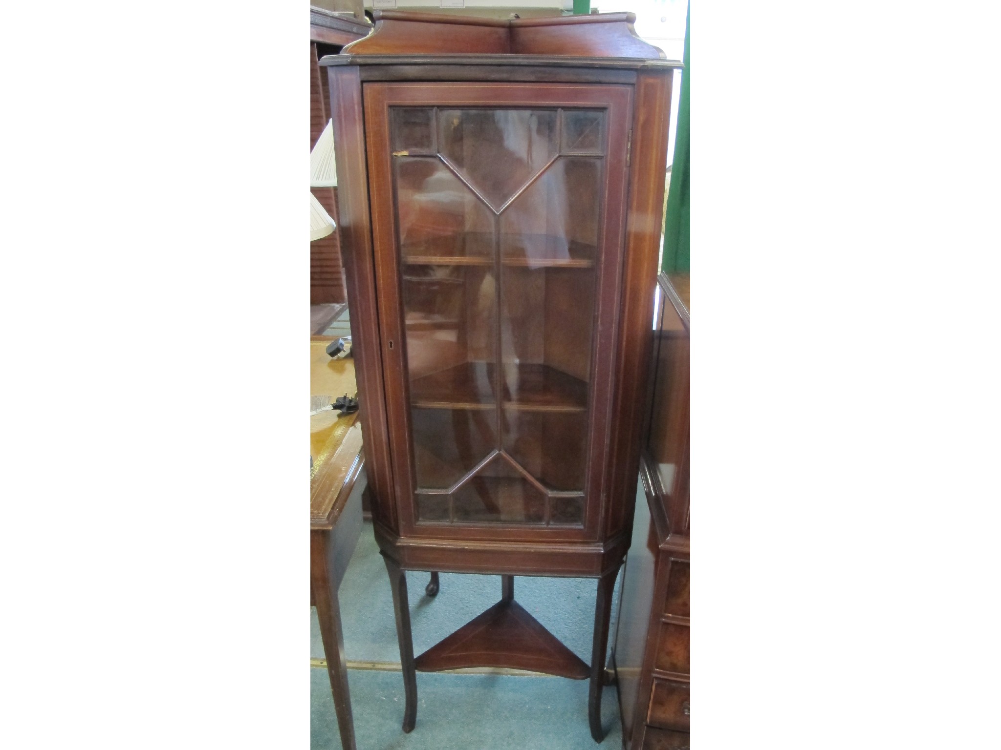 Appraisal: An Edwardian mahogany inlaid corner cabinet