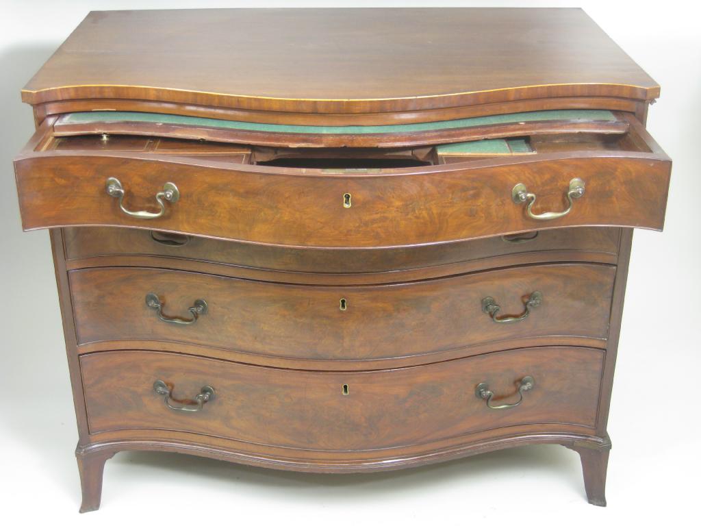 Appraisal: A George III mahogany serpentine shaped Chest of four long