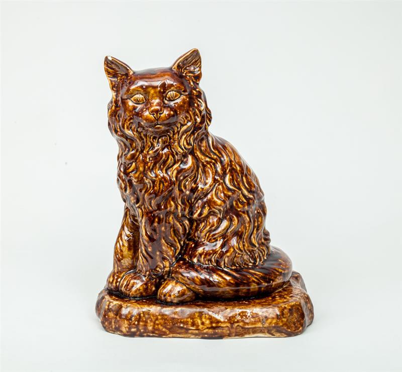 Appraisal: Rockingham Type Tortoise-Glazed Pottery Figure of a Seated Cat x