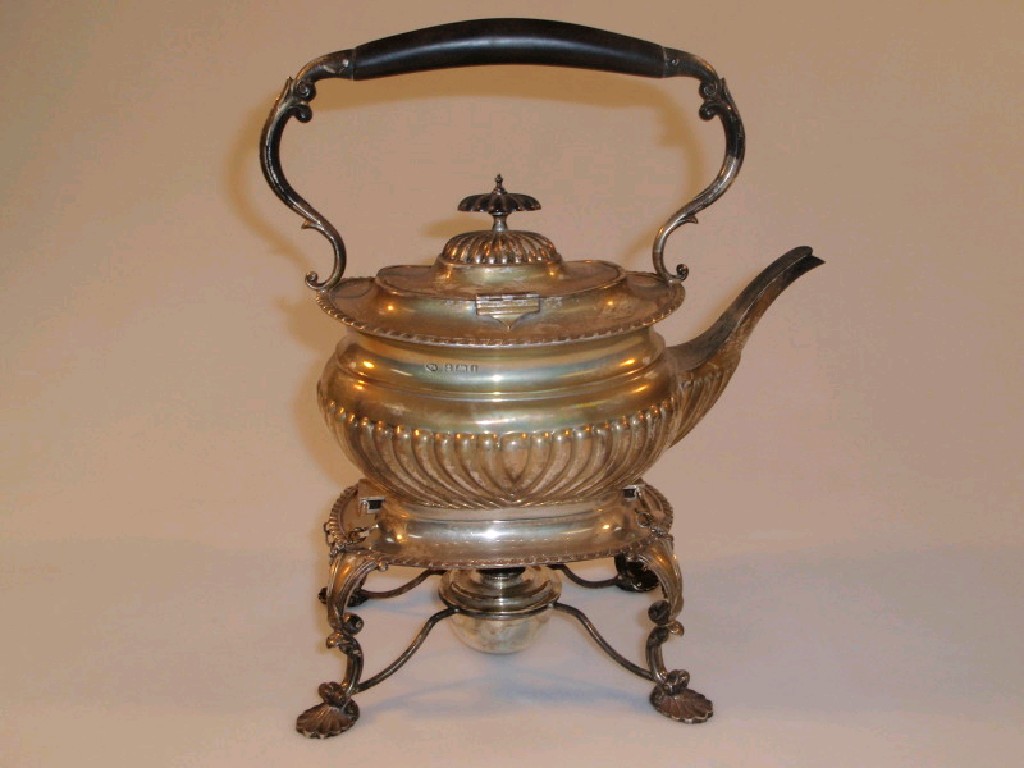 Appraisal: An Edwardian silver spirit kettle on stand of gadrooned and