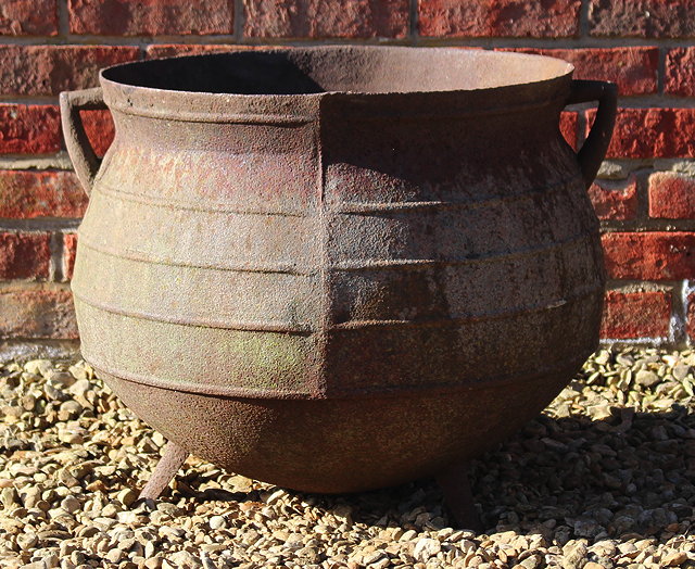 Appraisal: AN OLD CAST IRON CAULDRON with twin angled handles and