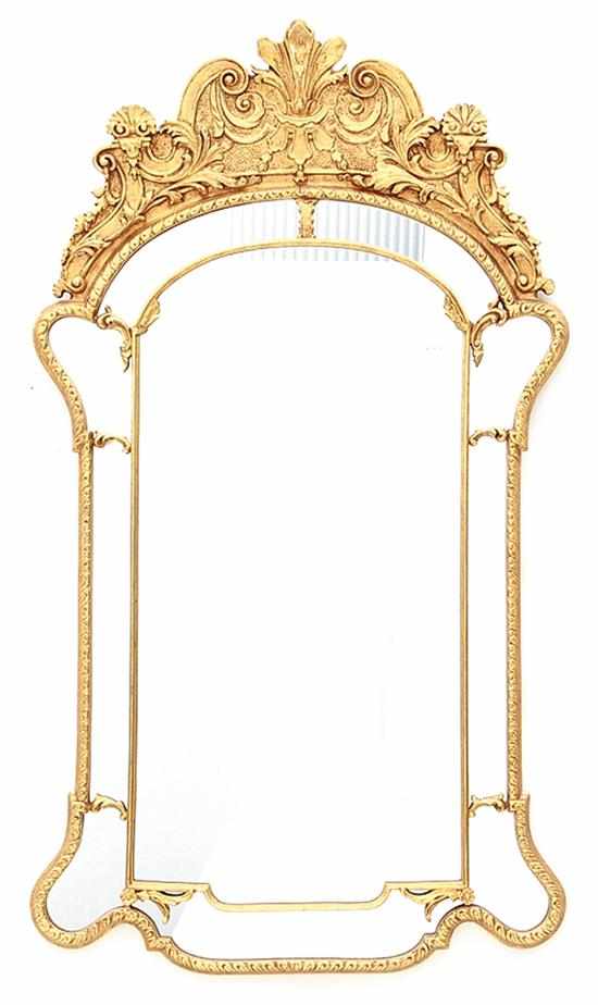 Appraisal: Carved giltwood pier mirror rocaille medallion cresting mirror plate encompassed