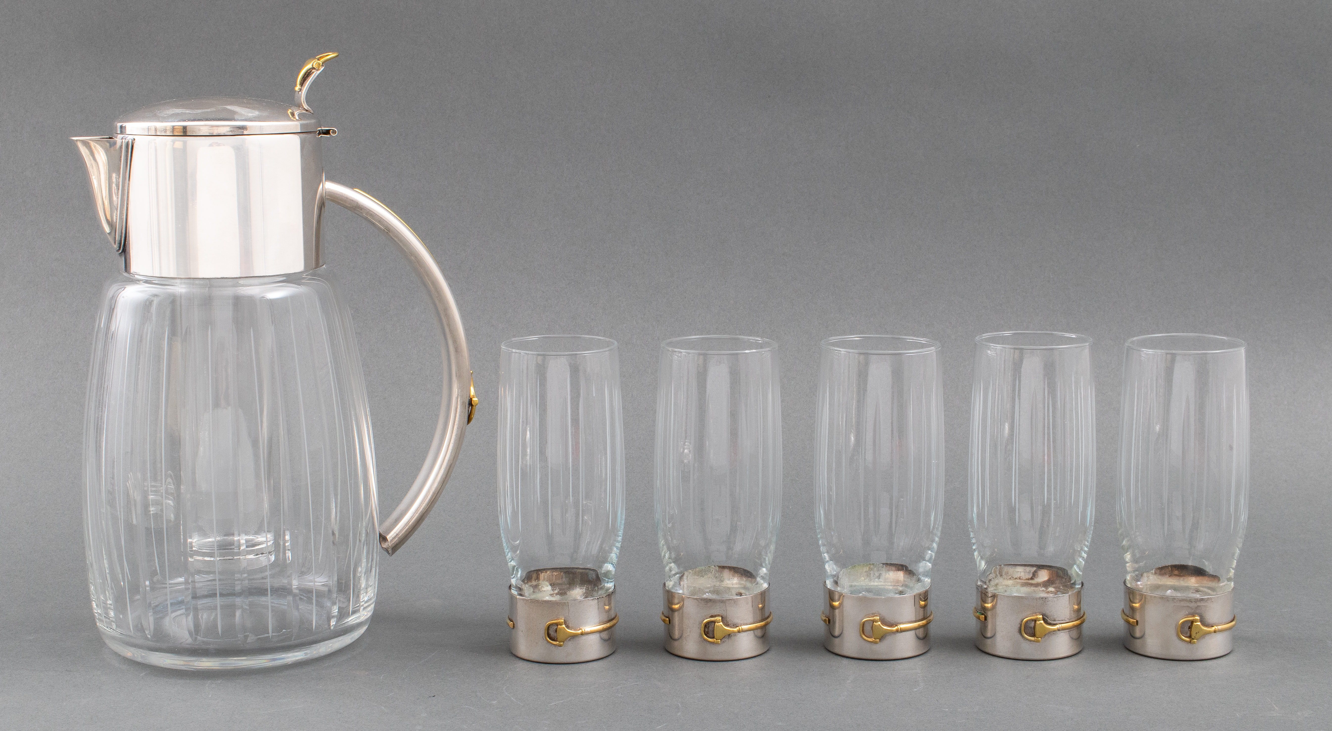 Appraisal: GUCCI STAINLESS STEEL BRASS GLASS DRINK SERVICE Gucci modern stainless