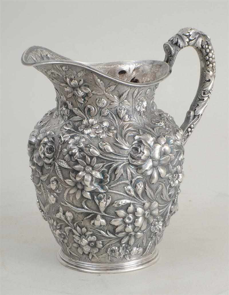 Appraisal: JACOBI CO REPOUSS SILVER WATER PITCHER Richly decorated with floral