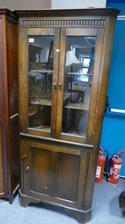 Appraisal: Carved oak glazed corner display cabinet