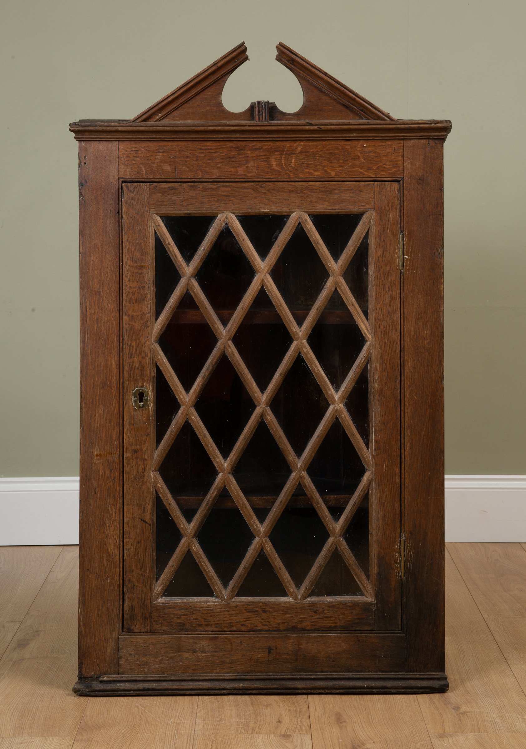 Appraisal: A th century oak hanging corner cupboard with break arch