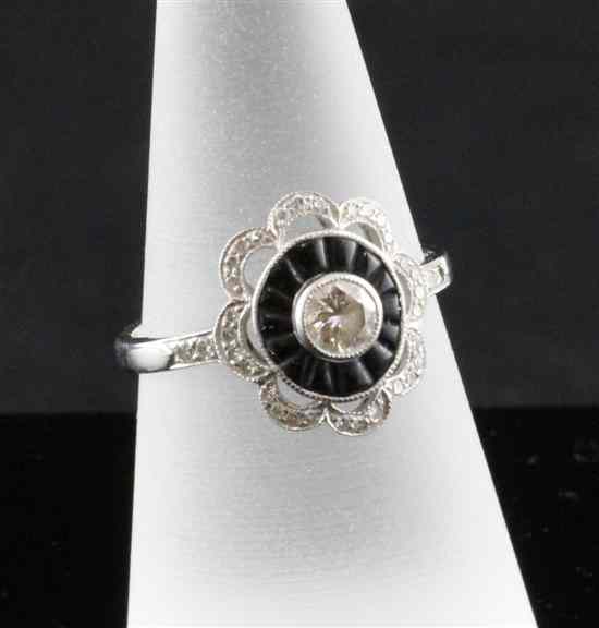 Appraisal: An ct white gold diamond and black onyx cluster ring