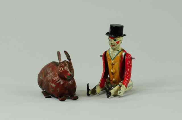 Appraisal: TUMBLING MAN AND RABBIT TOY Germany both hand painted overall