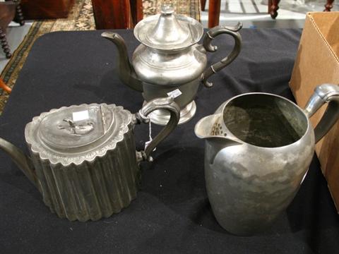 Appraisal: TWO PEWTER TEAPOTS AND A WATER PITCHER The first oval