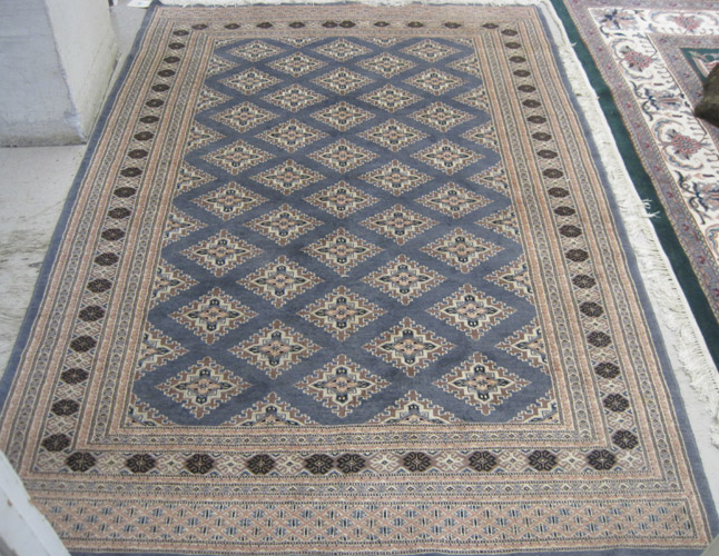 Appraisal: HAND KNOTTED ORIENTAL CARPET Indo-Bokhara featuring repeating rows of diamond-shaped