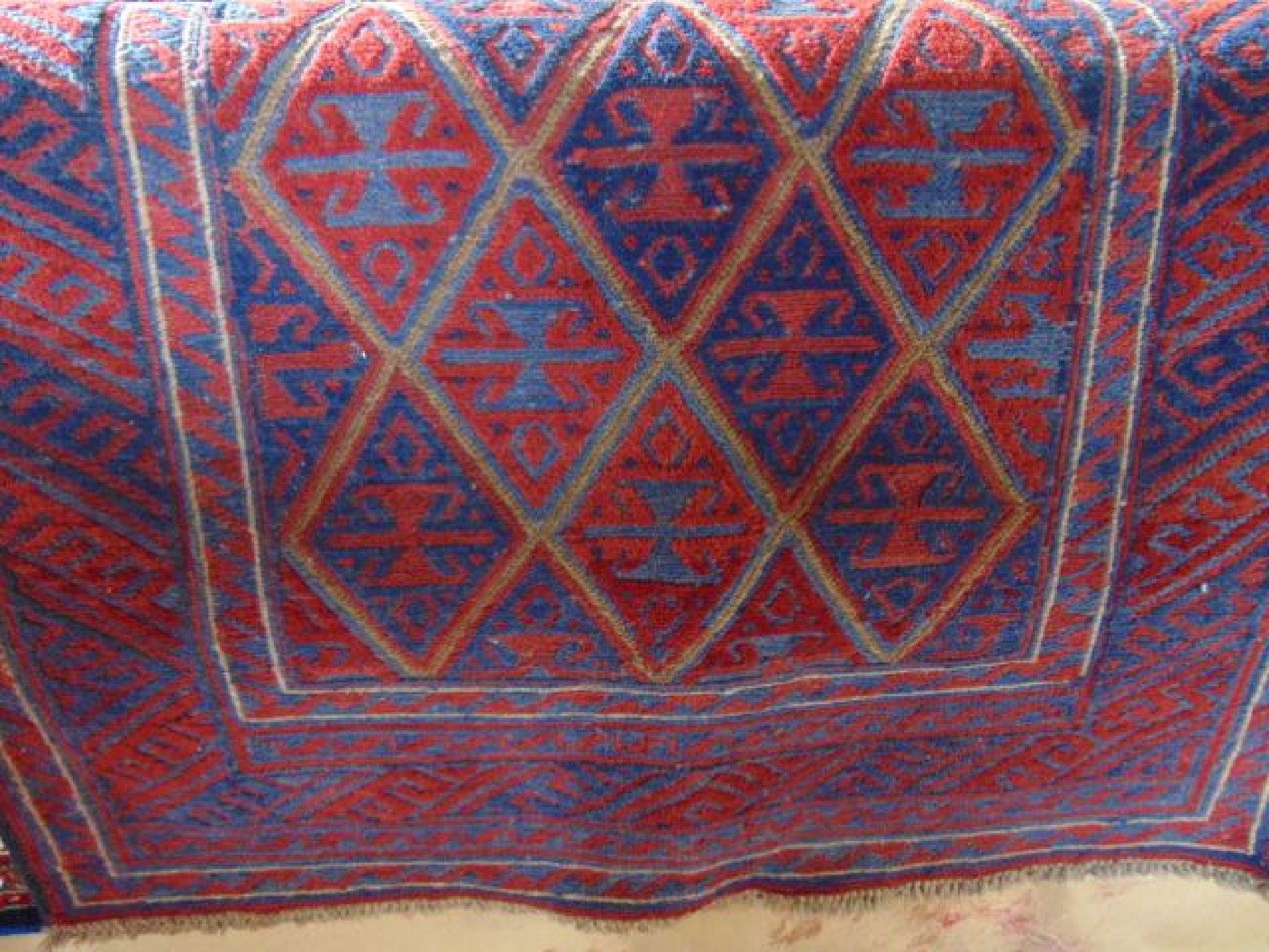 Appraisal: An Eastern wool rug principally in a blue and red