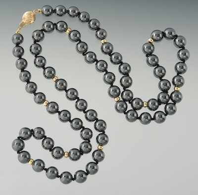 Appraisal: A Hematite and Gold Bead Necklace Individually strung hematite beads