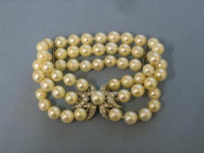 Appraisal: A PEARL AND DIAMOND BRACELET comprising three rows of uniform