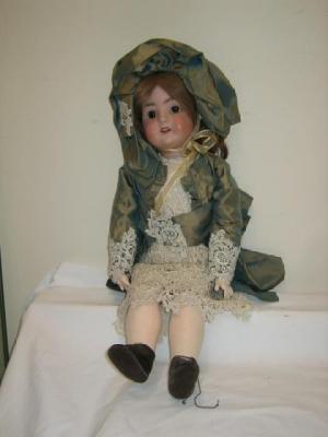 Appraisal: A Schoenau Hoffmeister bisque head girl doll with fixed brown