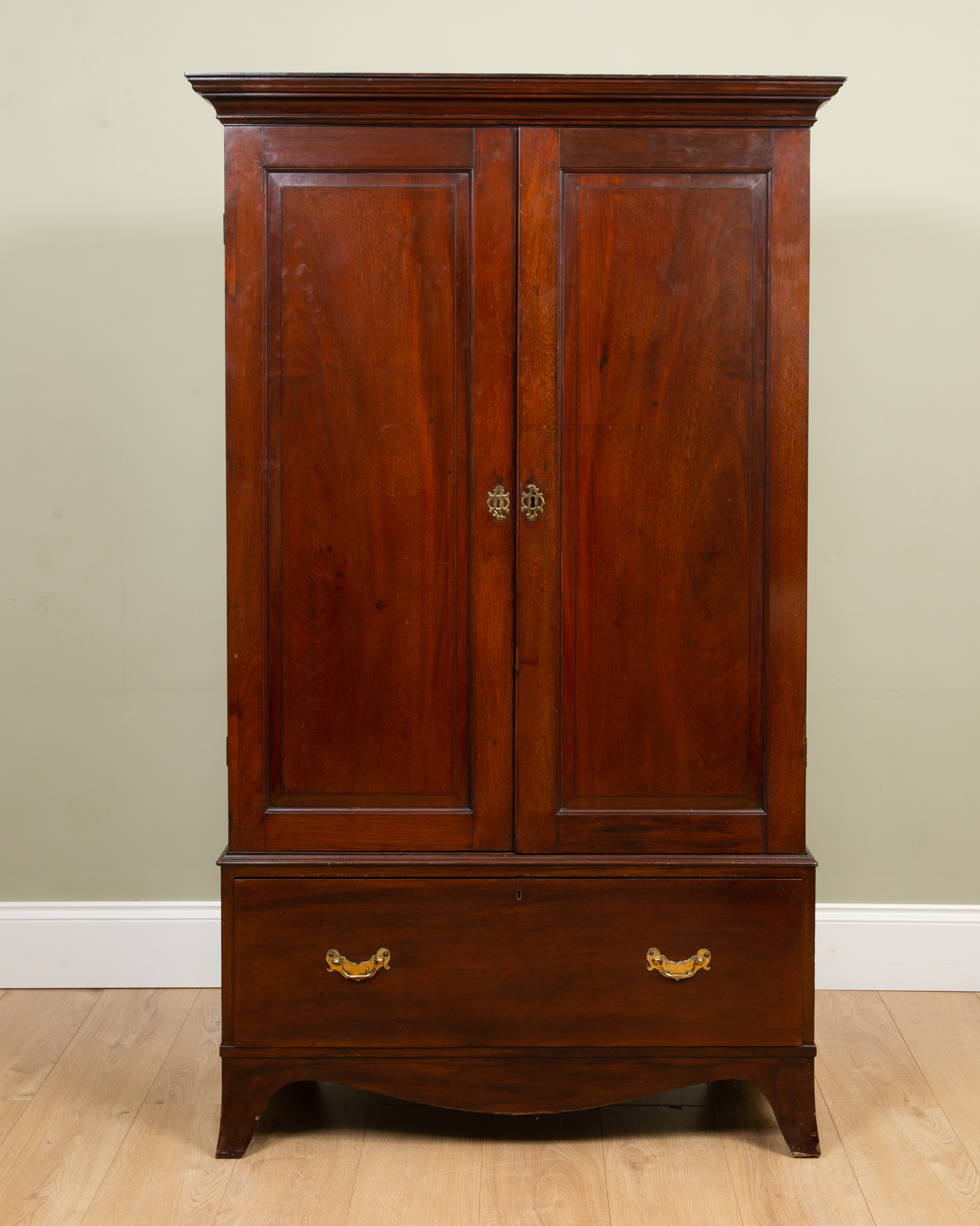 Appraisal: A Victorian mahogany cupboard the two doors enclosing shelves within