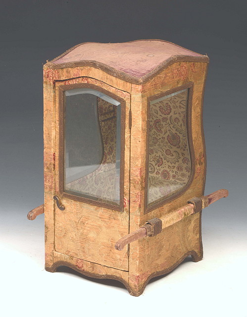 Appraisal: A MINIATURE SEDAN CHAIR with old fabric covering and glazed