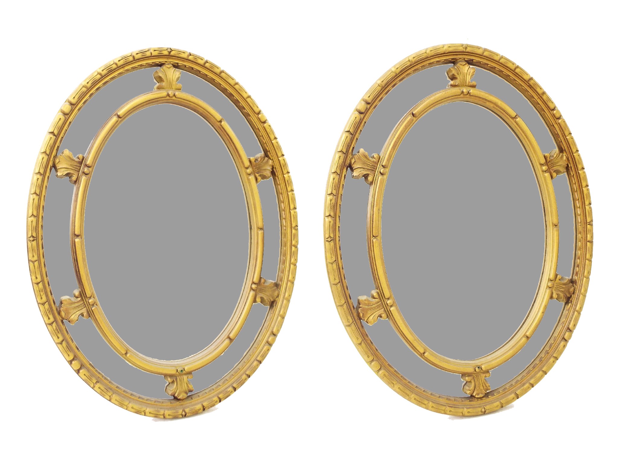 Appraisal: Pair of antique style oval gilded wall mirrors with acanthus